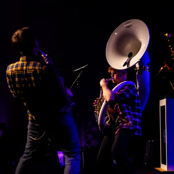 Musiker von Duke Brass spielt Sousaphon bei einem Bühnenauftritt